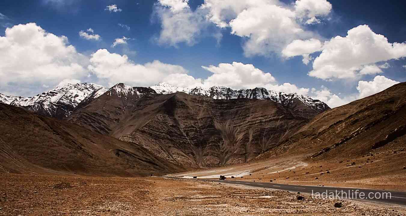 Scenic view of Magnetic Hill Ladakh surrounded by barren Himalayan mountains and Leh-Kargil road