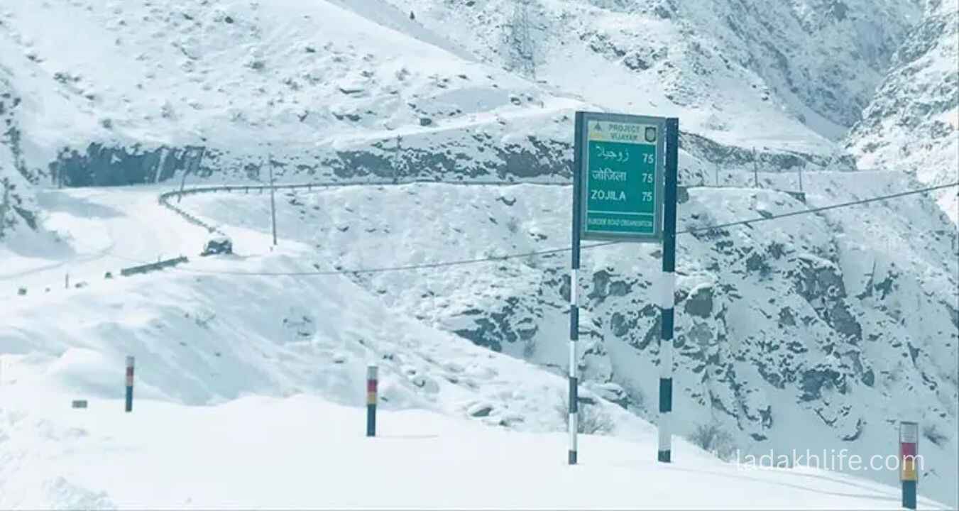 Vehicles and bikers crossing Zoji La Pass rugged Himalayan terrain